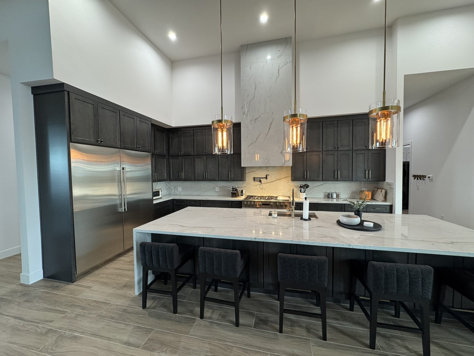 Dark custom kitchen cabinetry with a large island, built by Dynamic Cabinetry