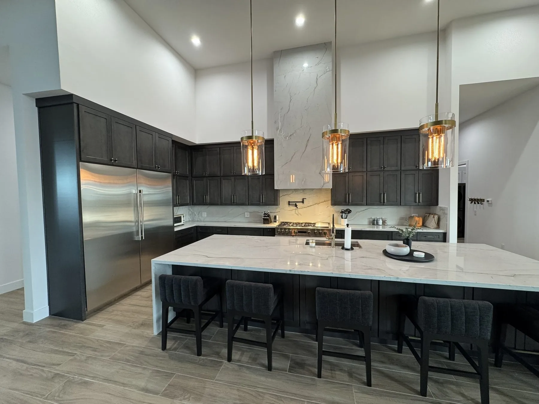 Dark custom kitchen cabinetry with a large island, built by Dynamic Cabinetry