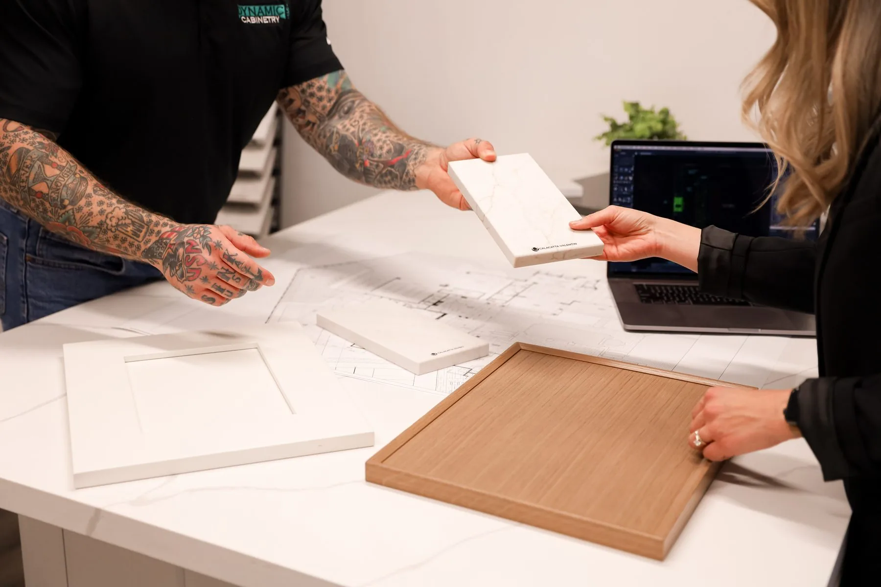 Reviewing a cabinet door sample during a design consultation