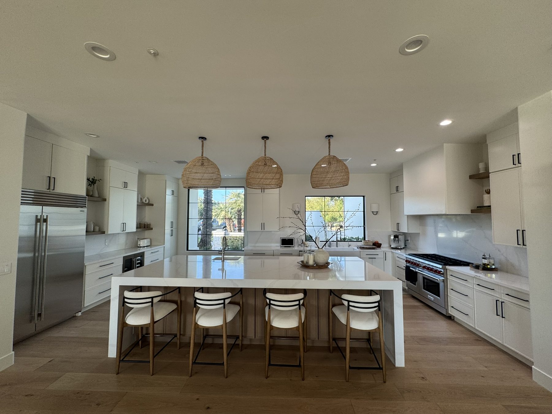 Bright custom kitchen with island seating and stainless appliances