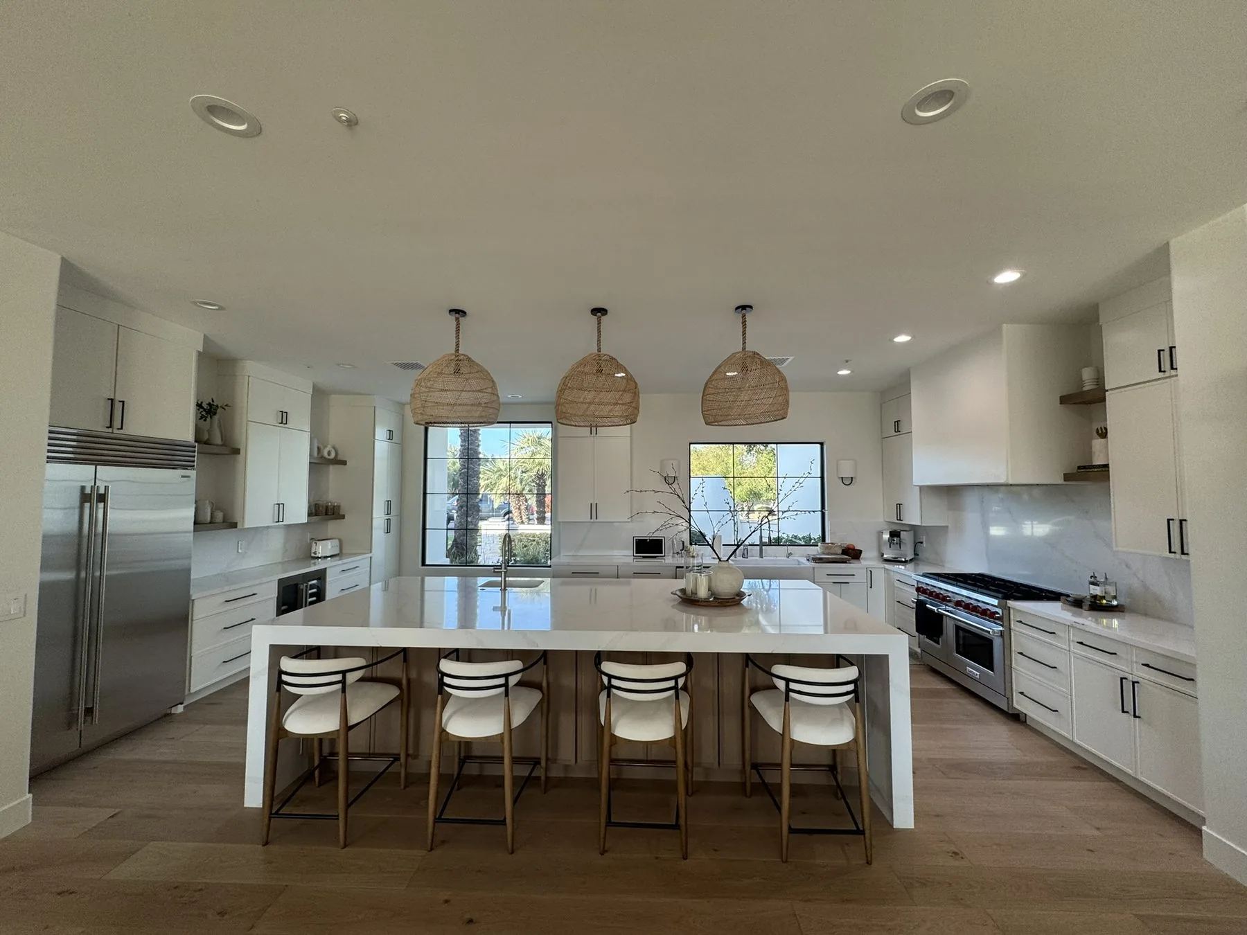 Bright custom kitchen with island seating and stainless appliances