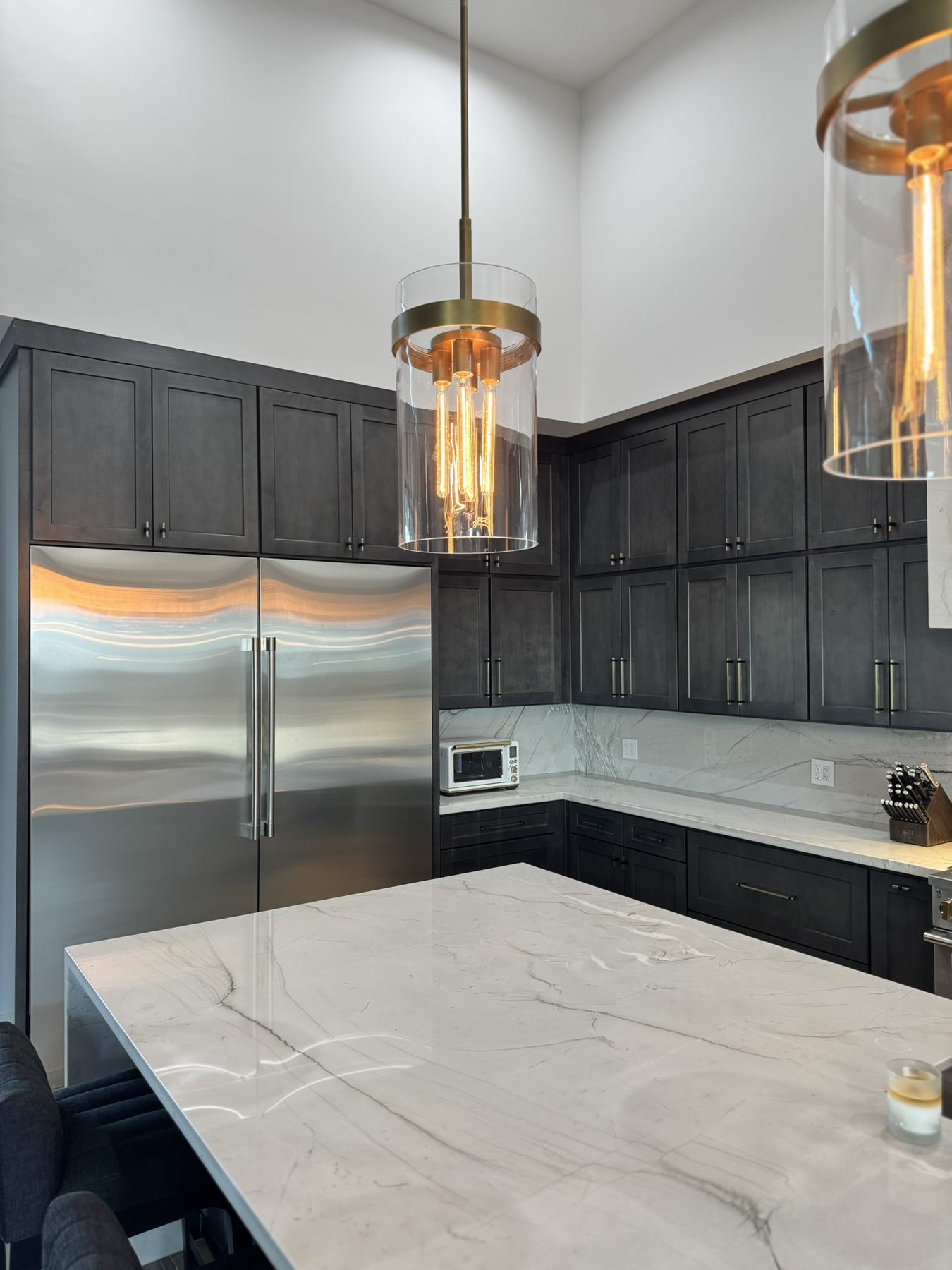 Marble waterfall countertop on a dark kitchen island