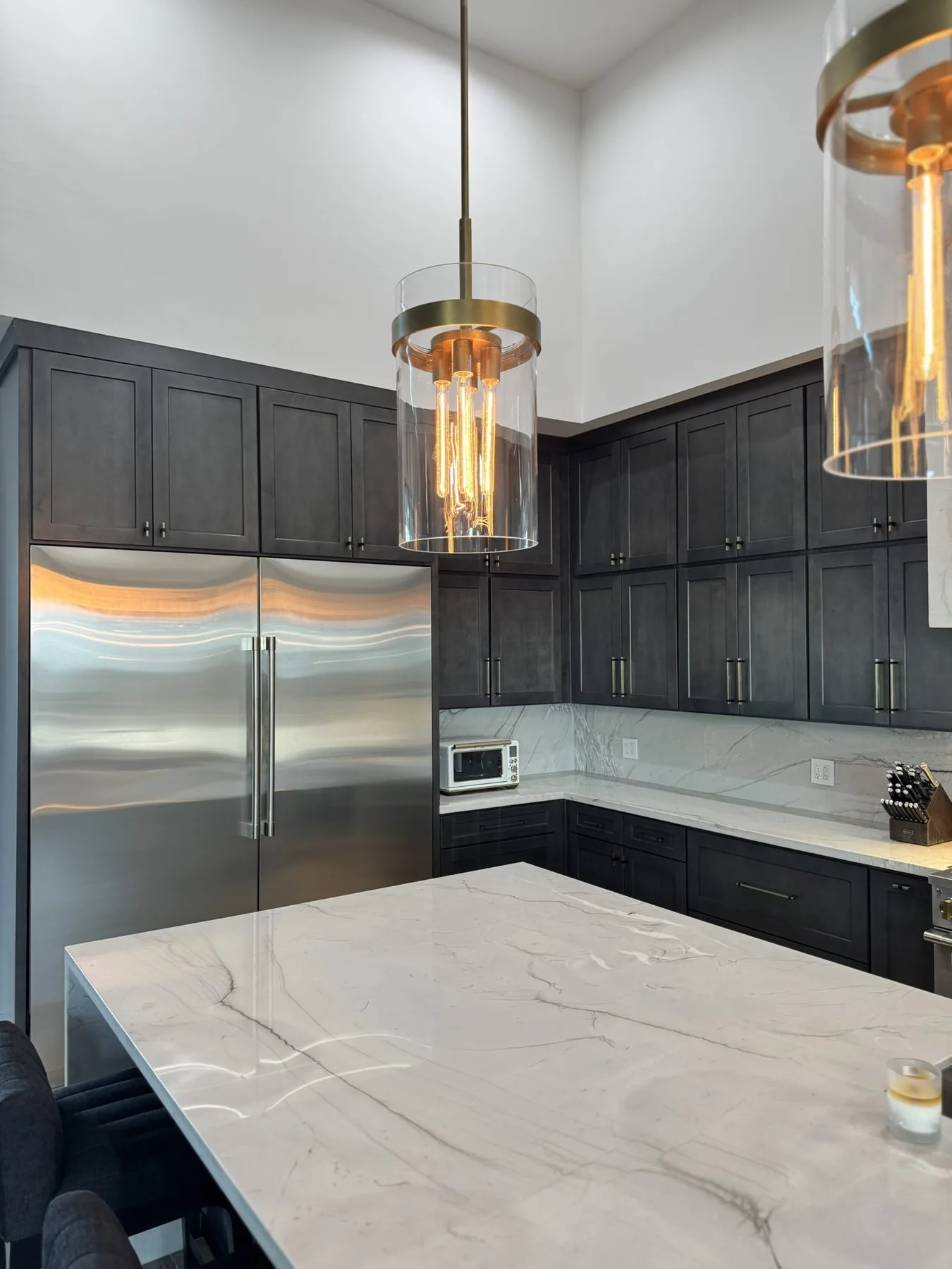 Marble waterfall countertop on a dark kitchen island